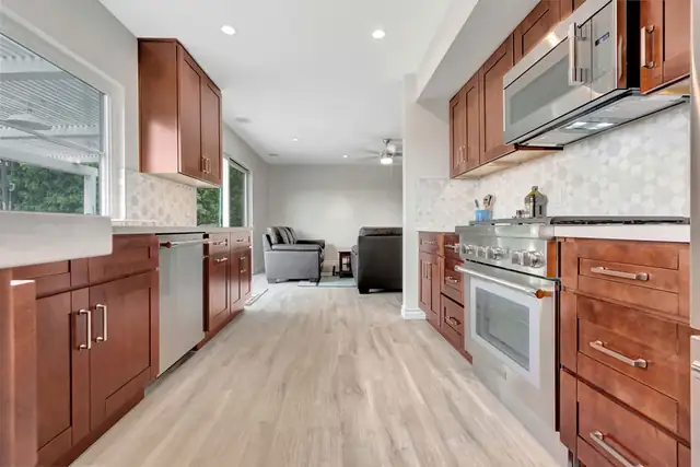 Mission Viejo galley kitchen remodel with walnut shaker cabinets, white quartz counters and hex tile backsplash